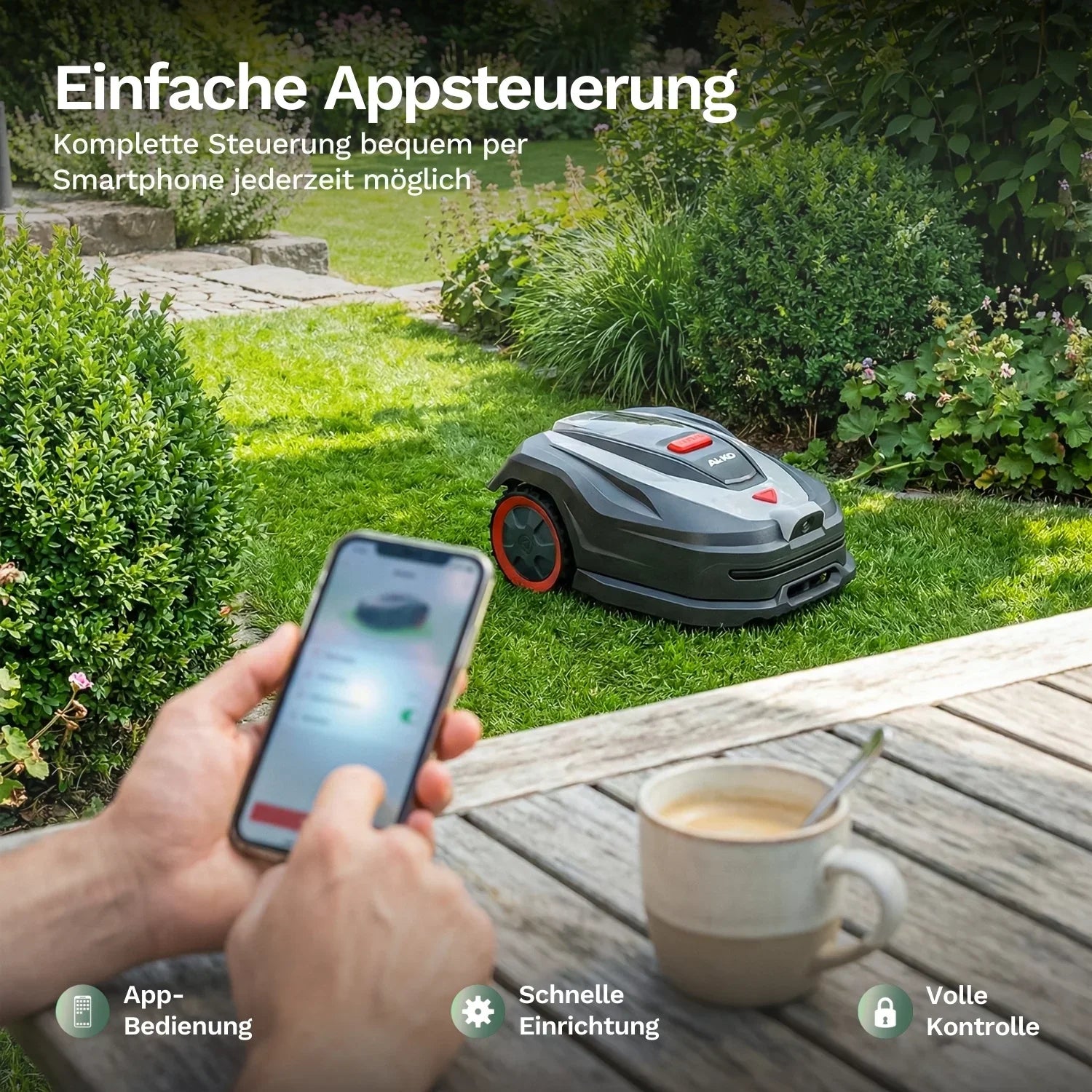 Mähroboter mit rotem Radring, bedient über Smartphone in der Hand im Vordergrund