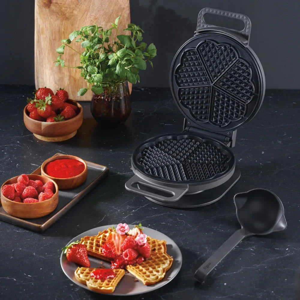 Waffle maker open with shaped waffle and serving scoop