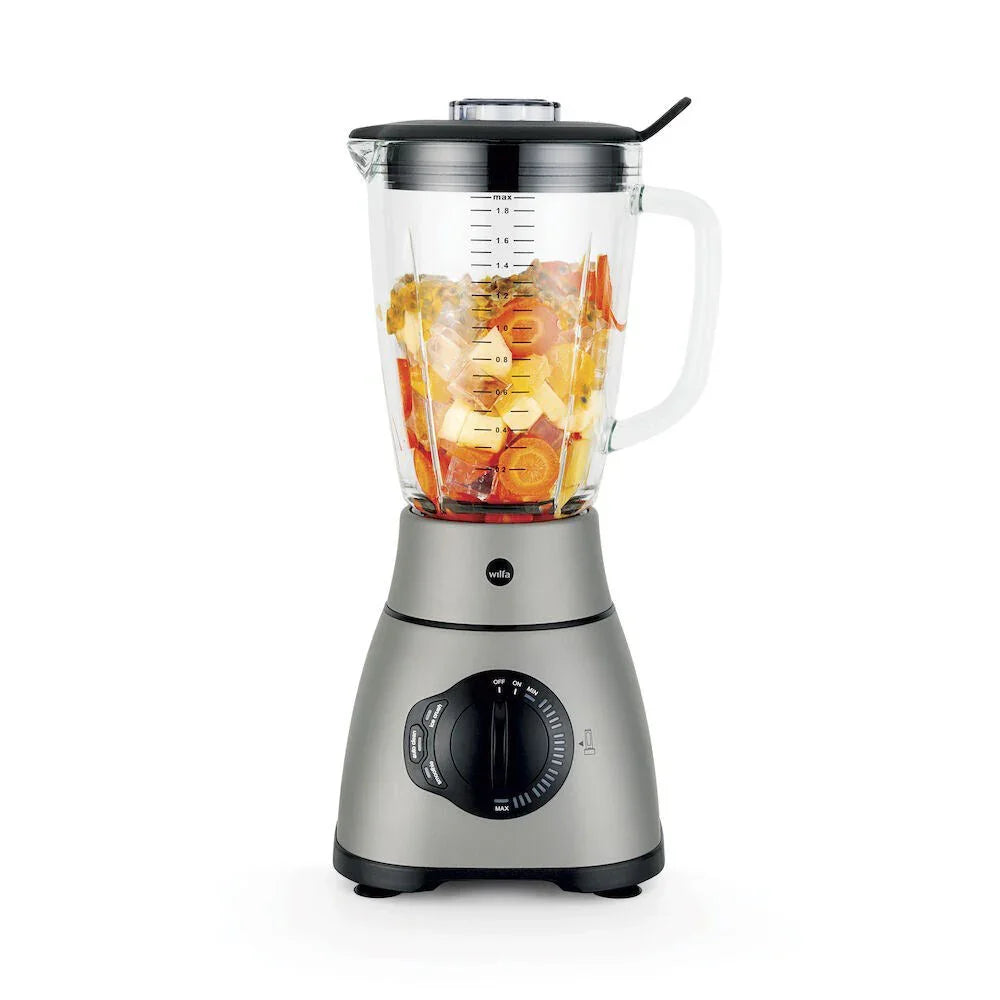 Stand mixer with glass jug filled with ingredients and adjustable speed dial